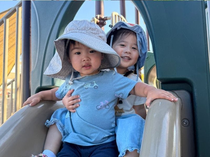 Two children on a playground slide