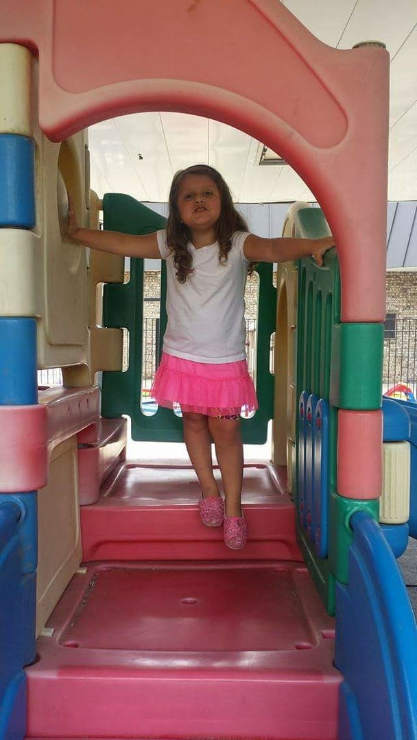 Child standing on a playground structure