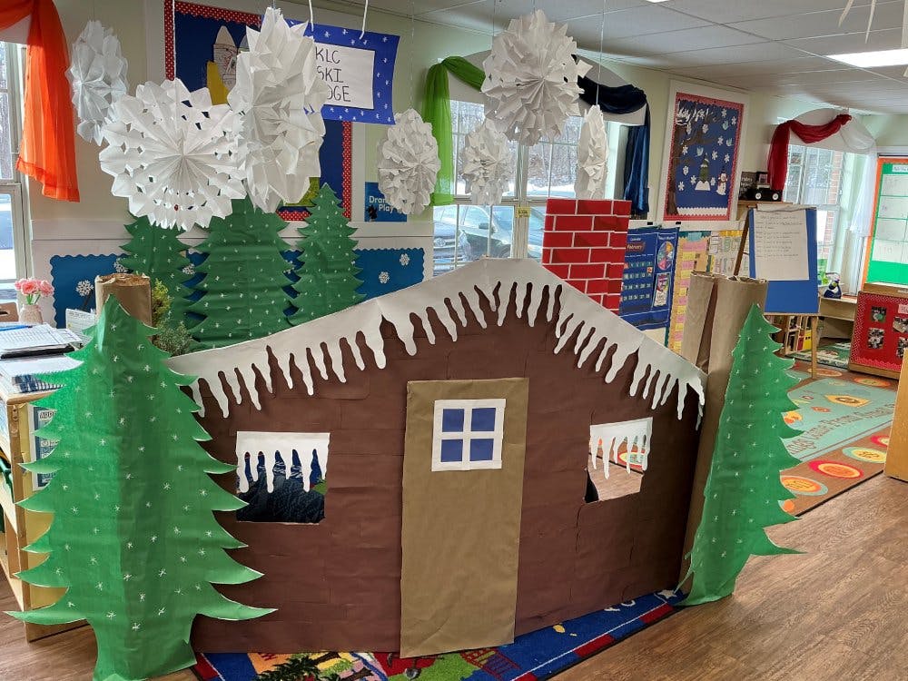 Classroom decorated with winter theme, a cardboard house with trees