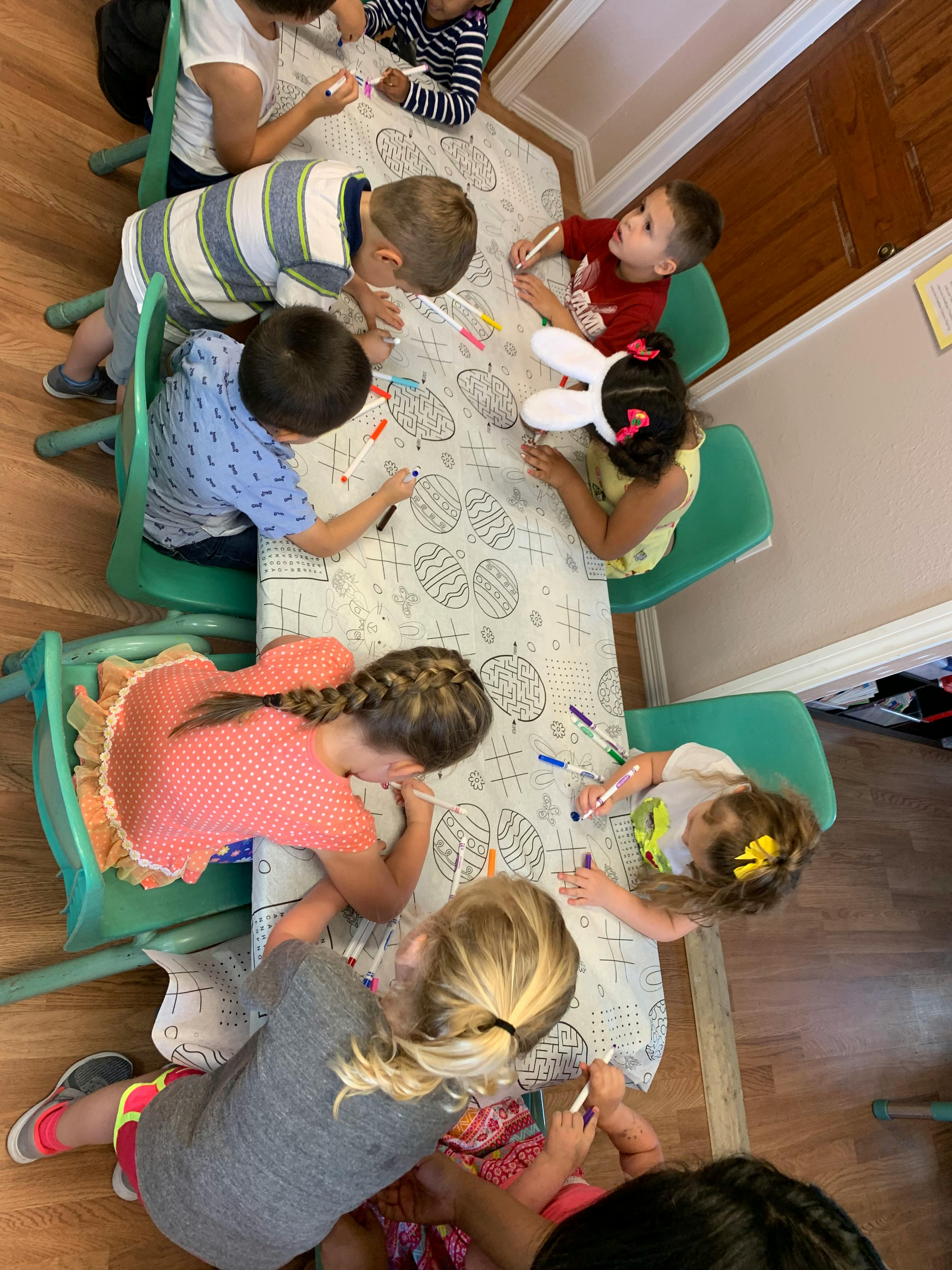 Children coloring at a table