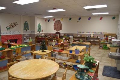 Classroom with tables, shelves, and decorations
