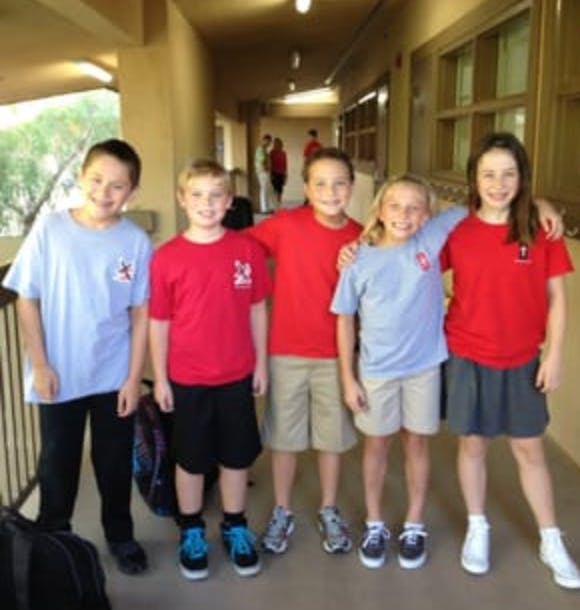 Five children standing in a hallway