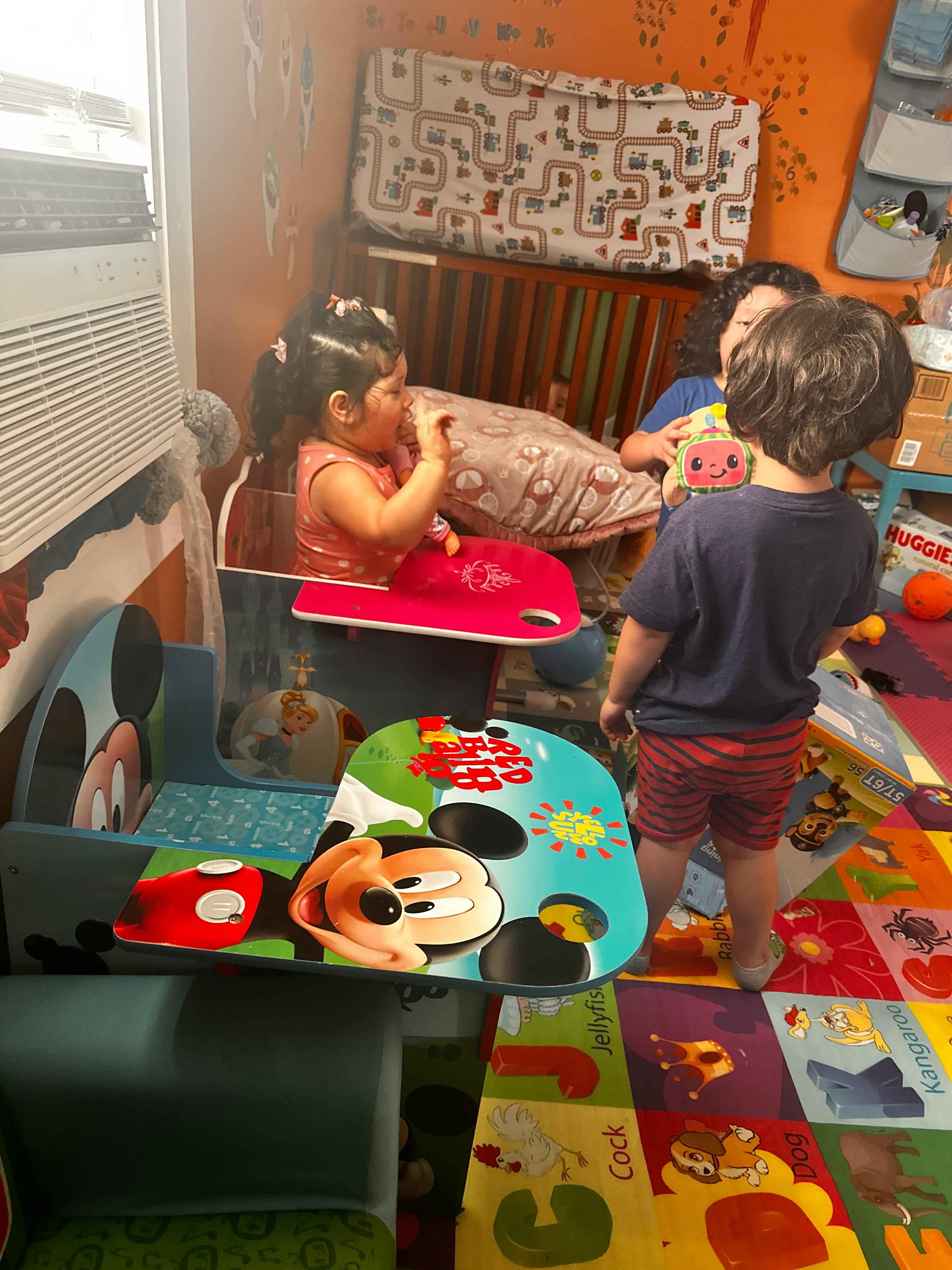 Three children playing in a room