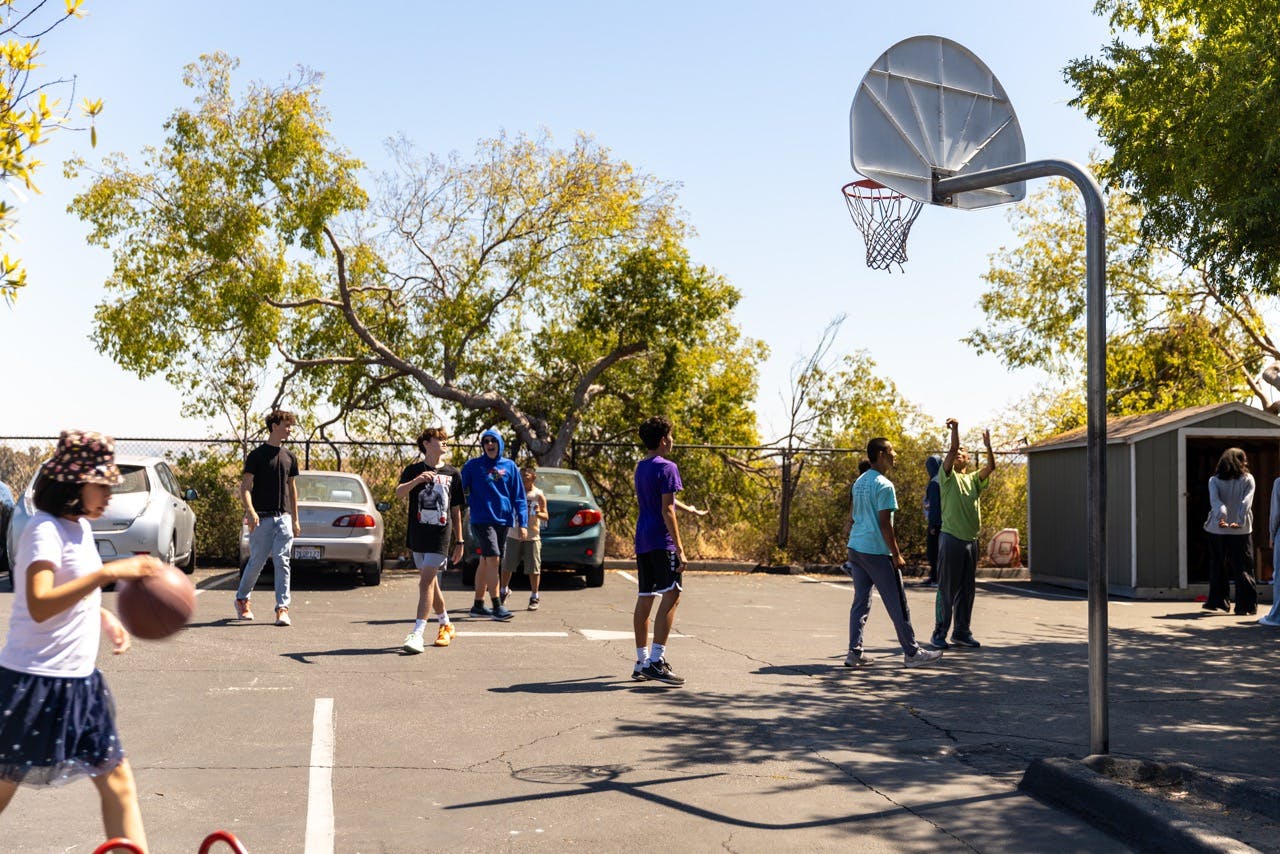 People playing basketball on an outdoor court
