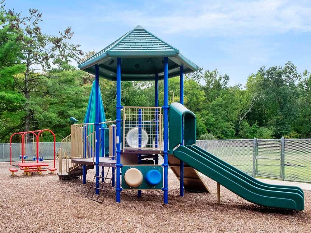 Playground with a slide and a small picnic table