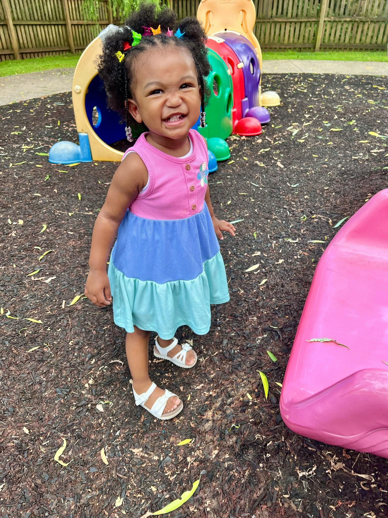 Child with barrettes in hair at a playground