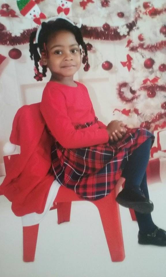 Child sitting on a red chair