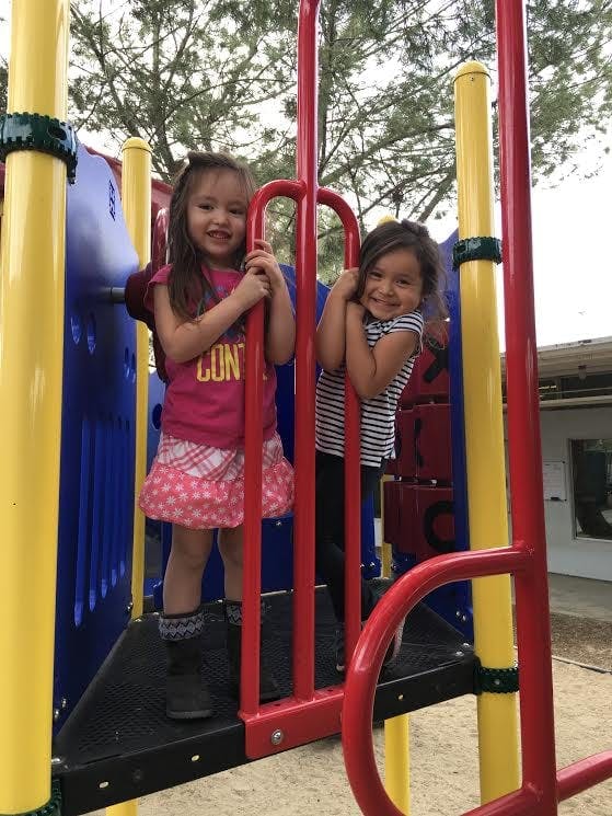 Two children on a playground structure