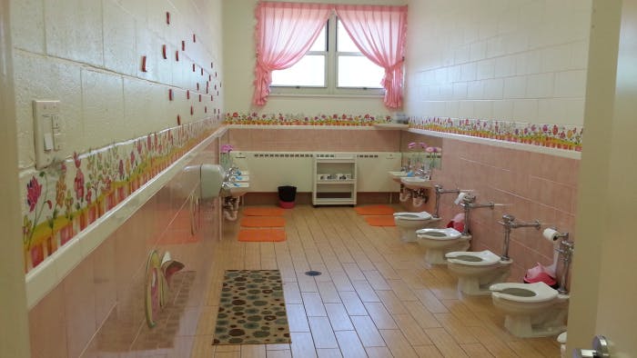 Row of small toilets in a children's bathroom
