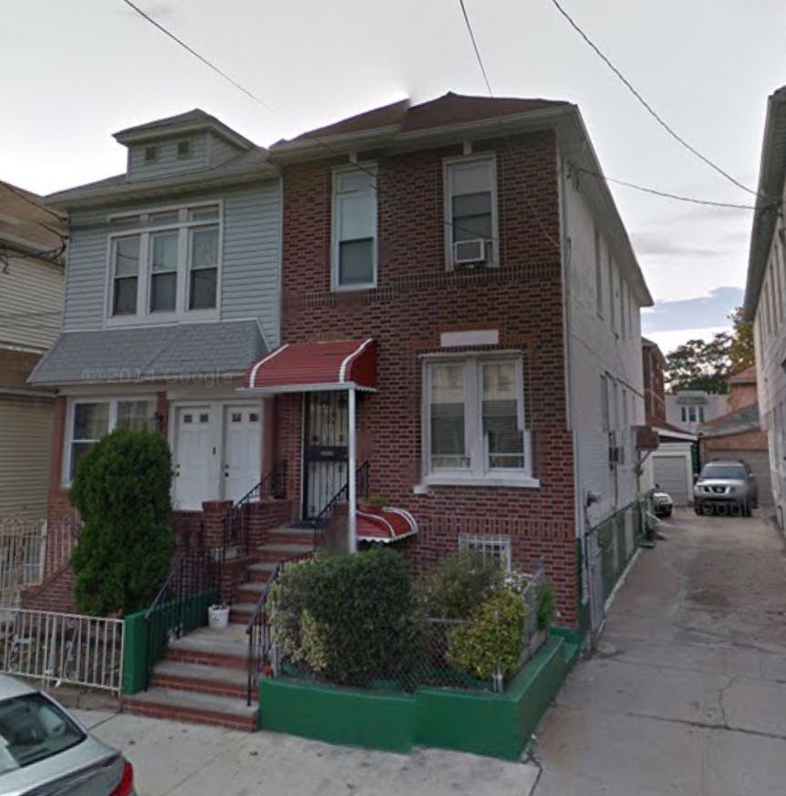 Two attached residential buildings with brick and siding facades