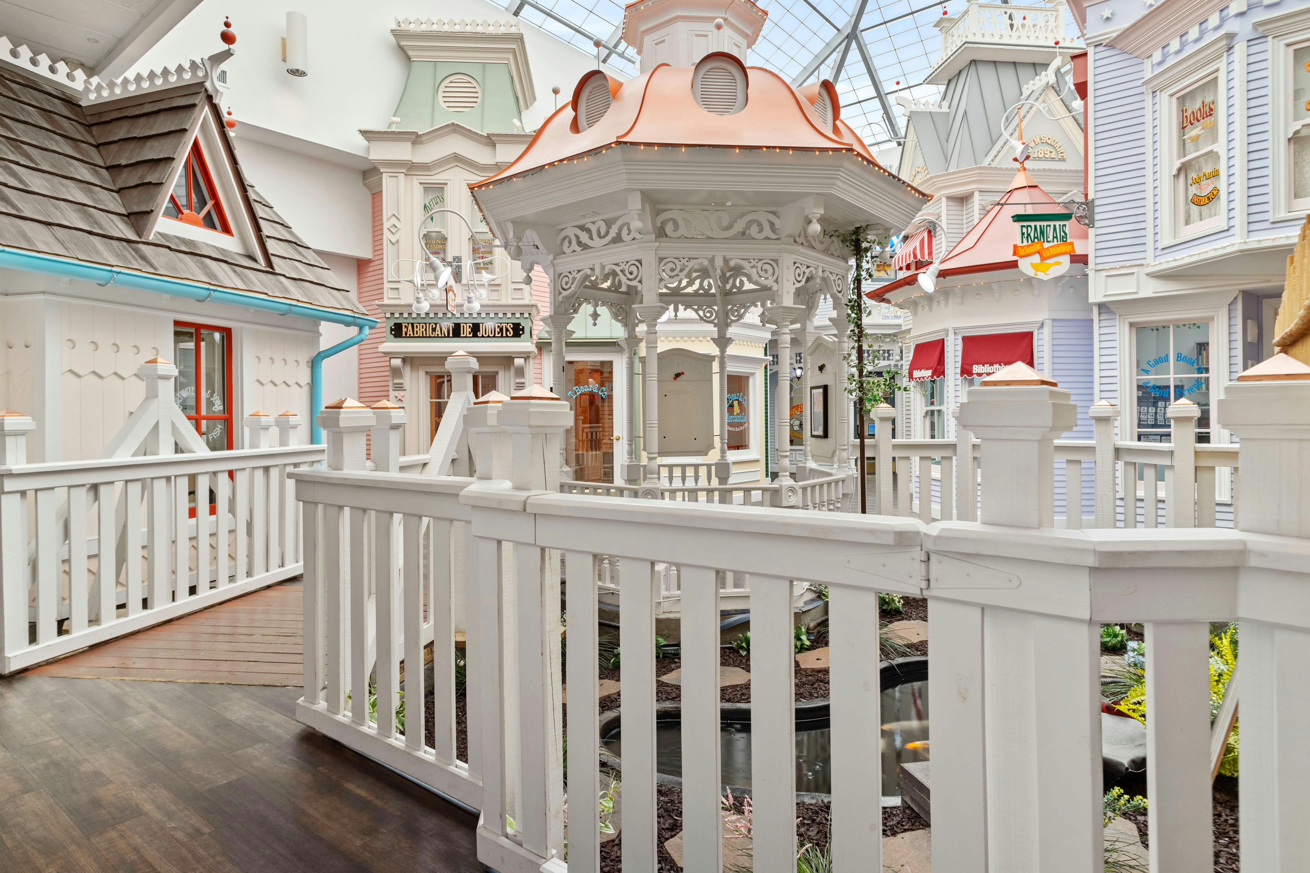 Miniature village with a white gazebo surrounded by small shops