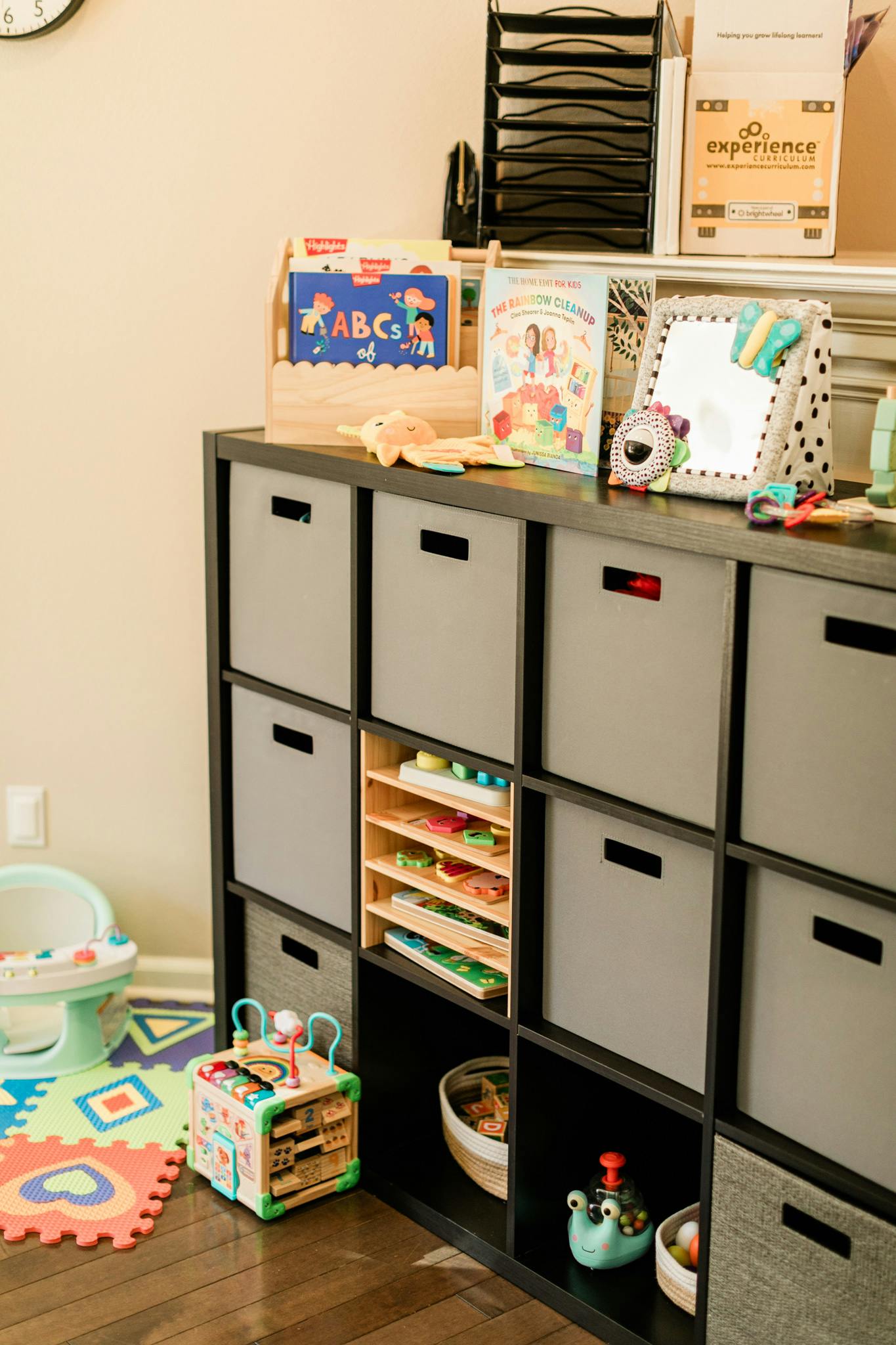 Storage unit with fabric bins and toys in a room