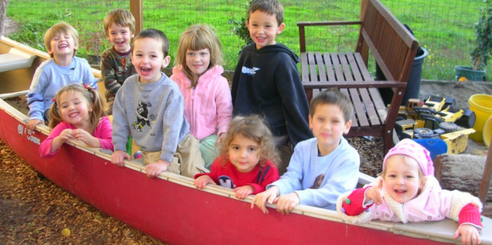 Group of children in a red canoe