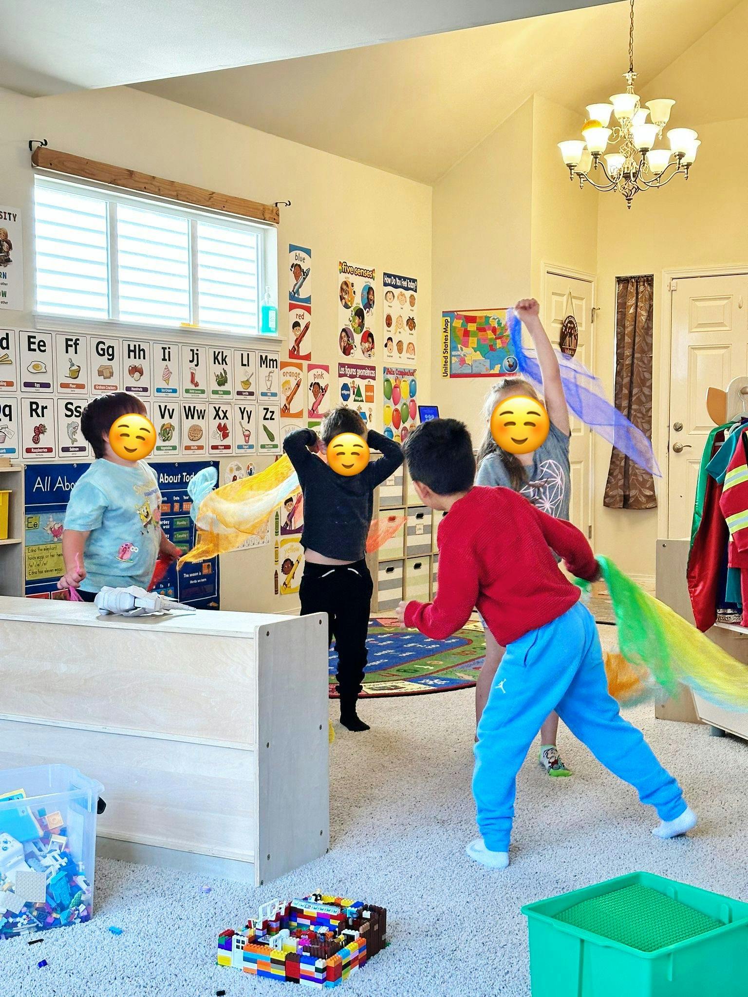 Children playing with colorful scarves in a classroom