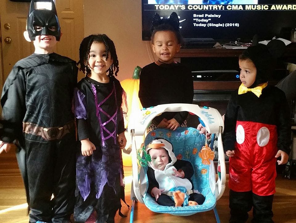 Four children and a baby in costumes