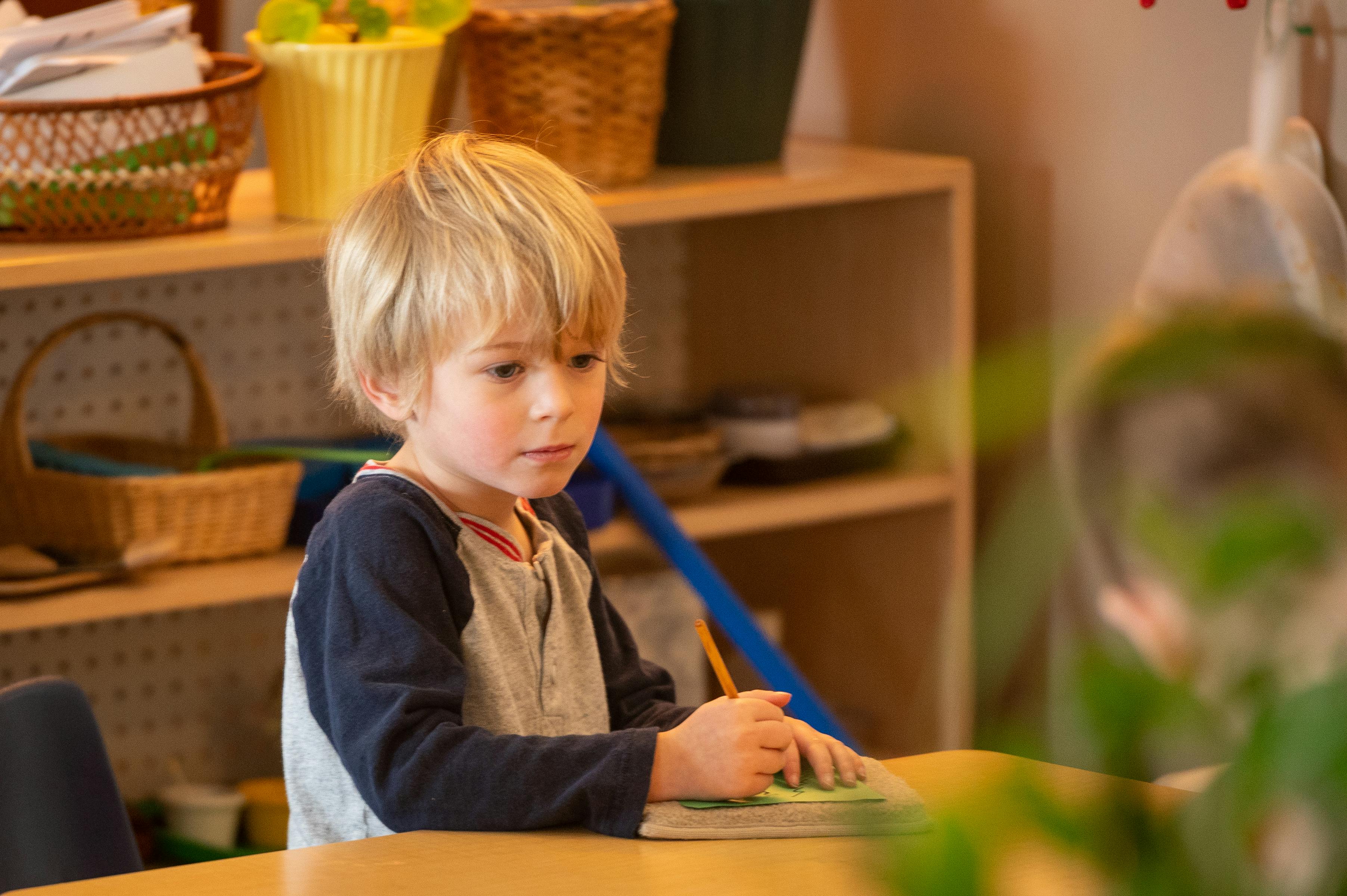 Child at a table with a book