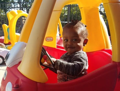 Child in a toy car