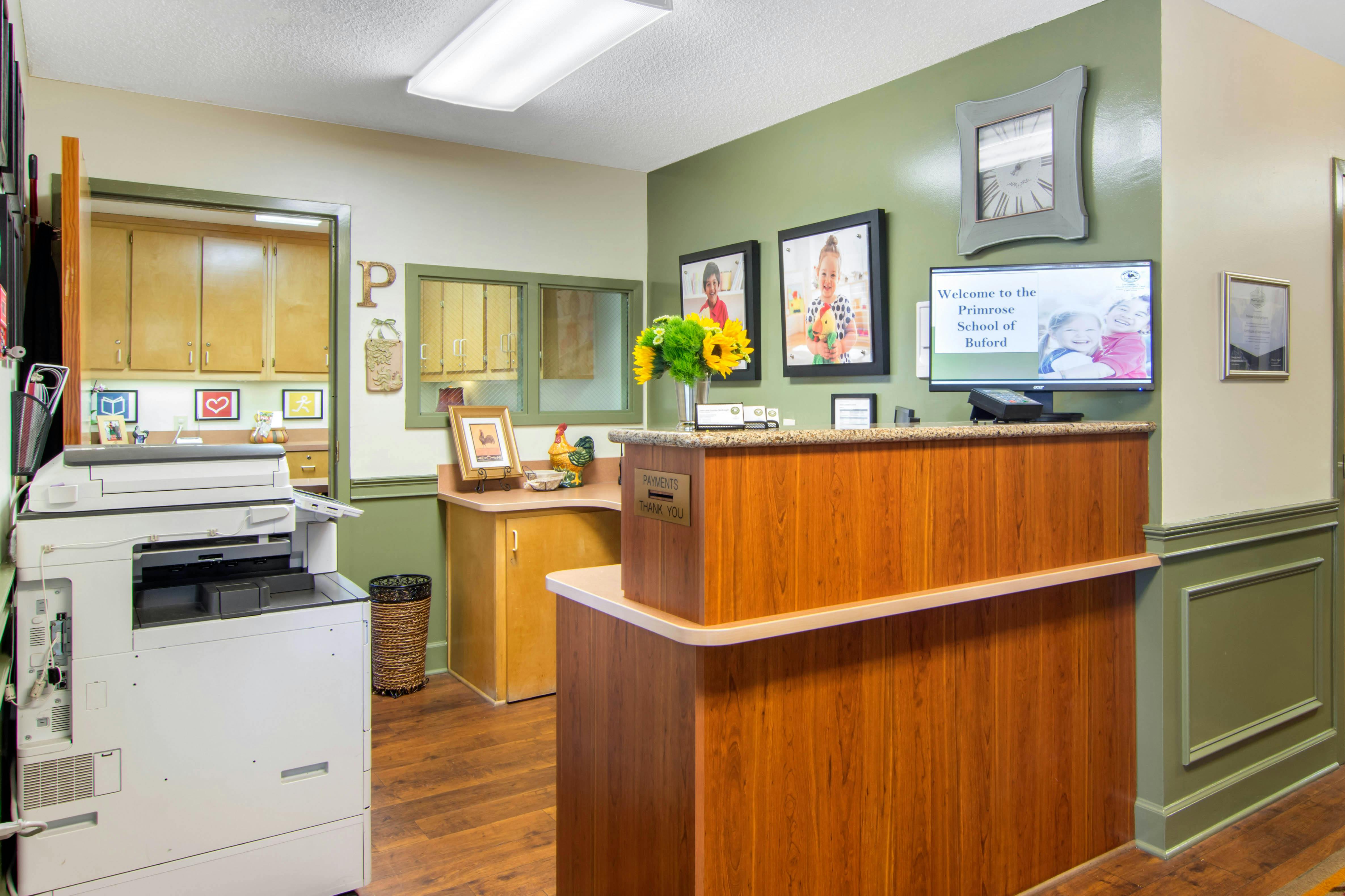 Reception desk with sunflowers and welcome sign in a school