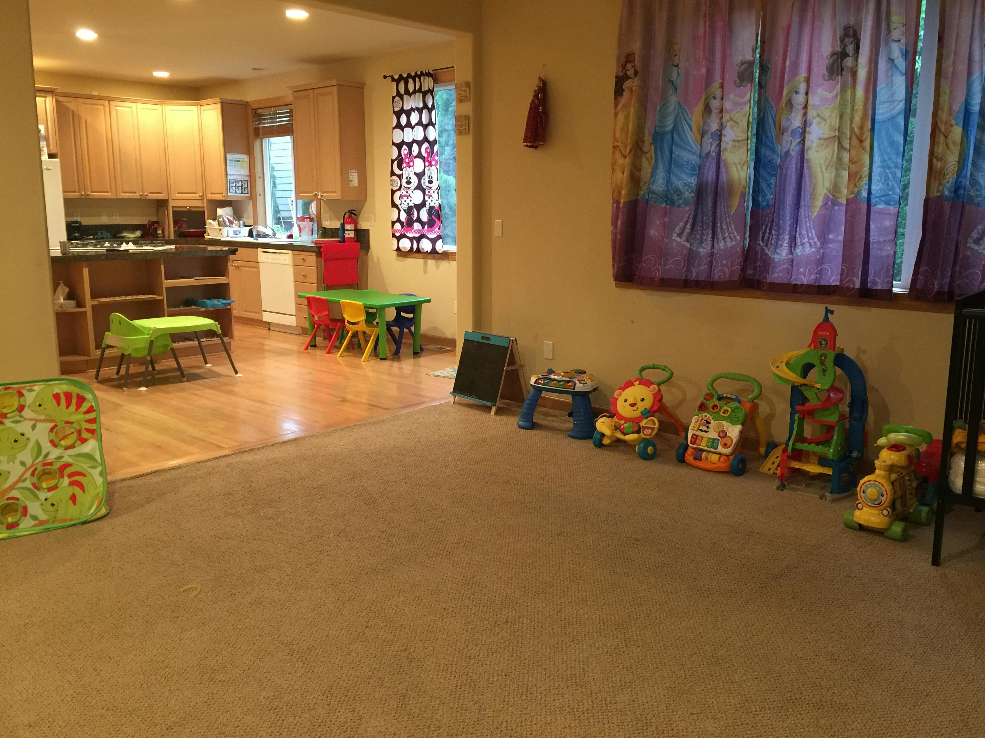 Playroom with toys and kitchen in background