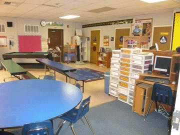 Classroom with tables, chairs, pool table, and computer desk with a computer desk