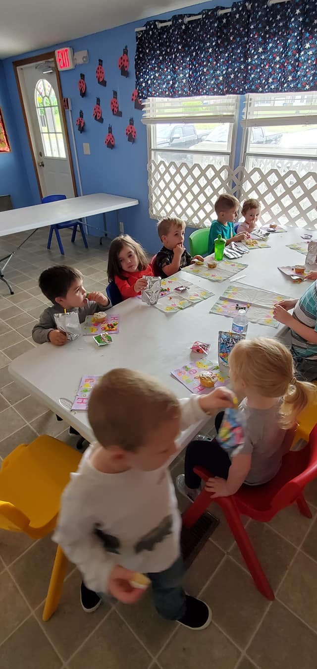 Children sitting at tables in a classroom