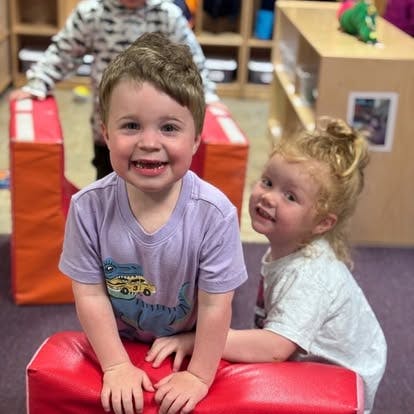 Children playing with foam blocks in a classroom