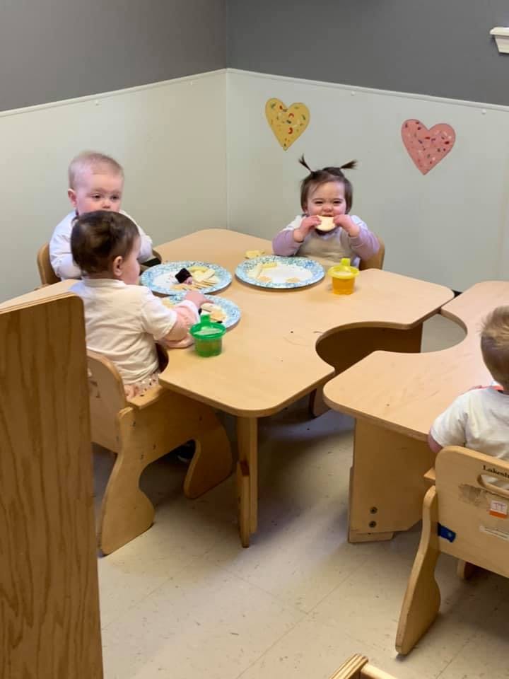 Three children eating at a table