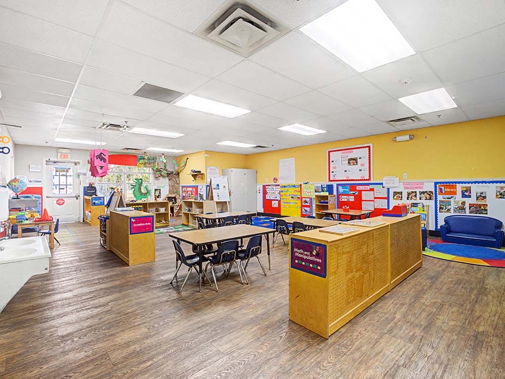 Classroom with tables, chairs, and learning materials