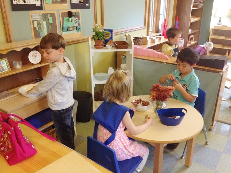 Children in a classroom engaged in various activities
