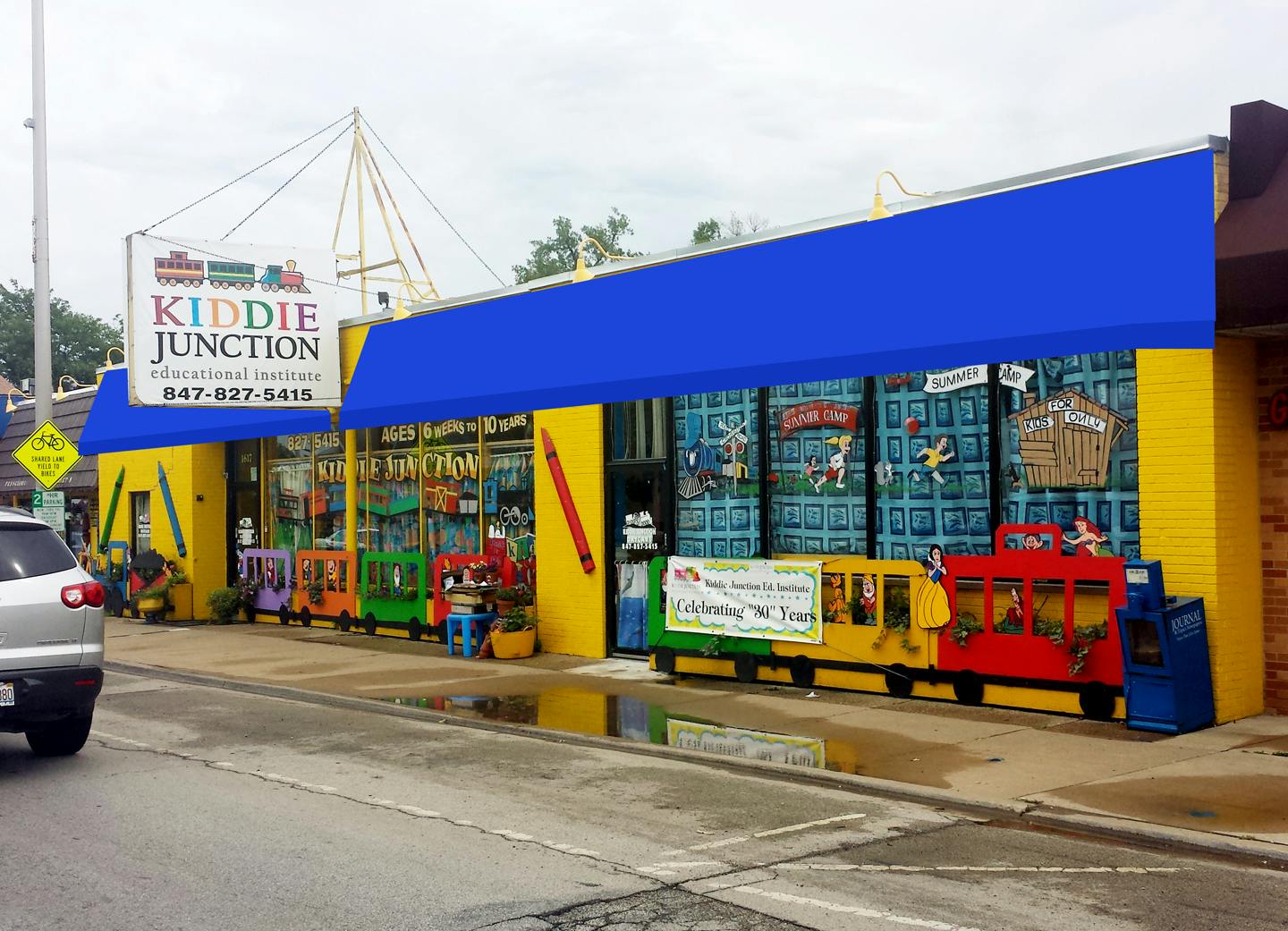 Kiddie Junction building with blue awning and colorful train decorations