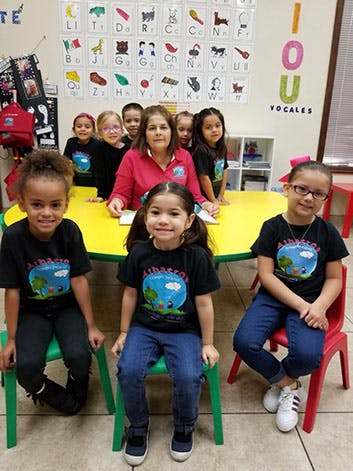 Adult and multiple children in a classroom