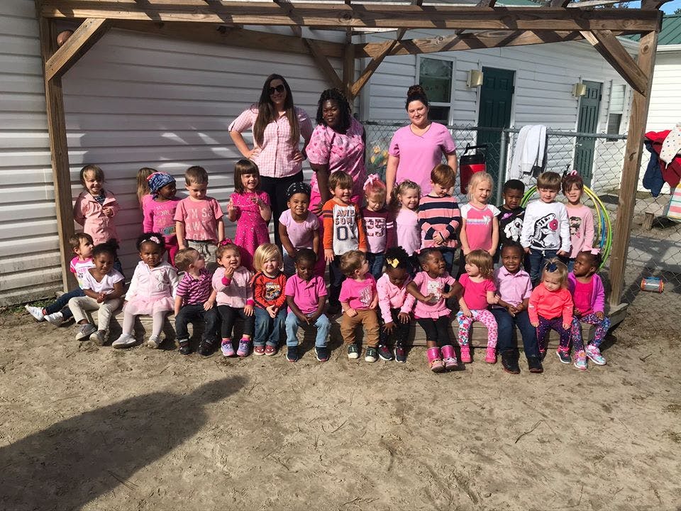 Group of adults and children posing outdoors