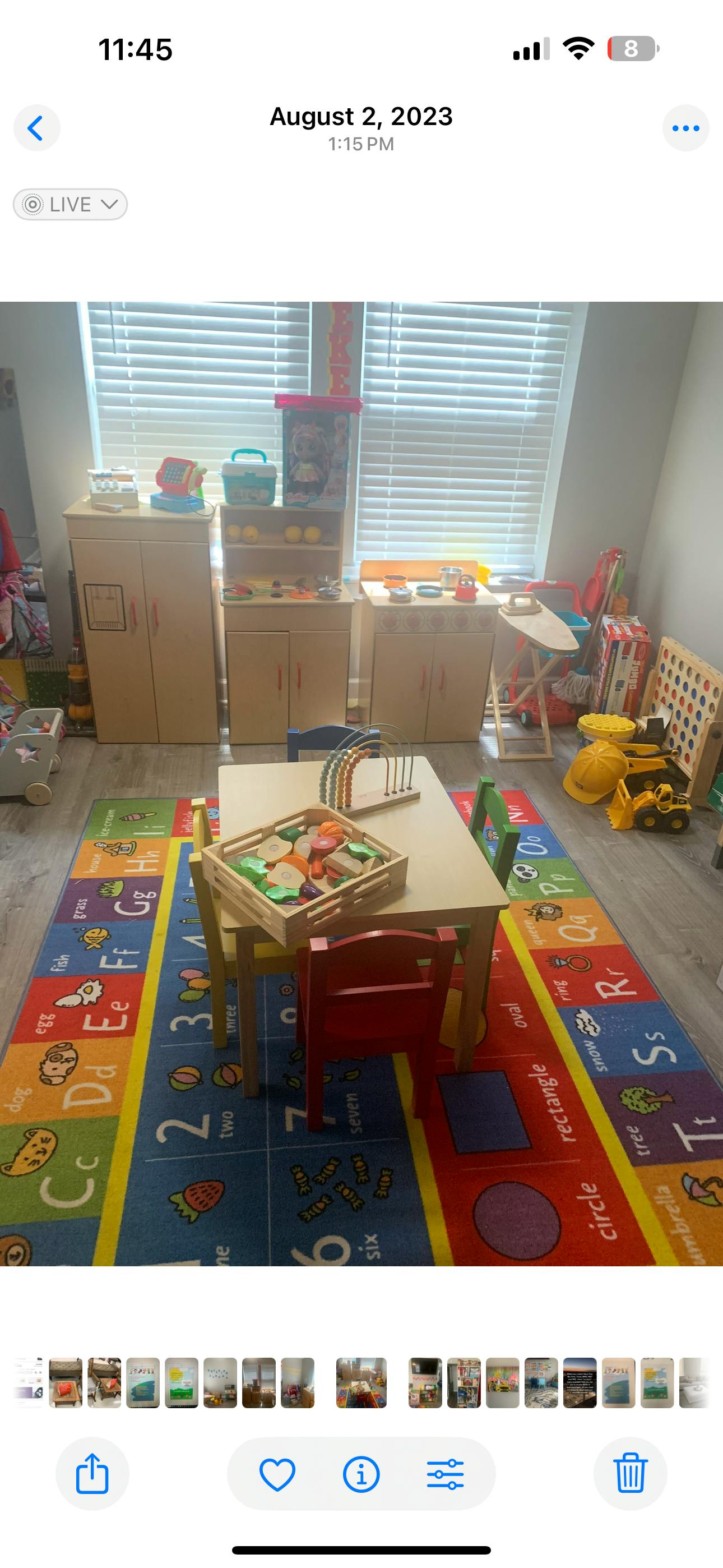 Children's play area with a table, chairs, and an alphabet rug