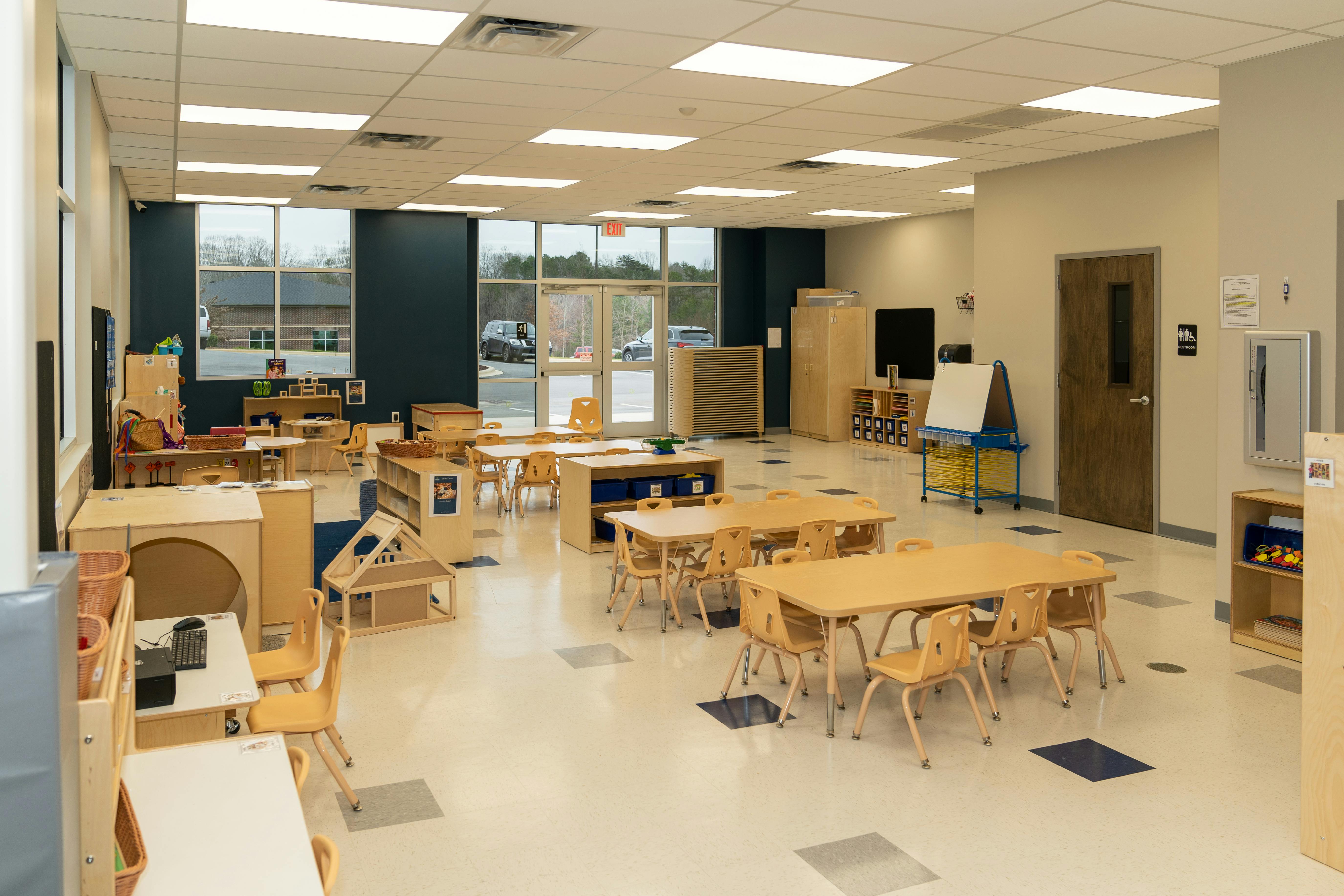 Empty classroom with small tables and chairs