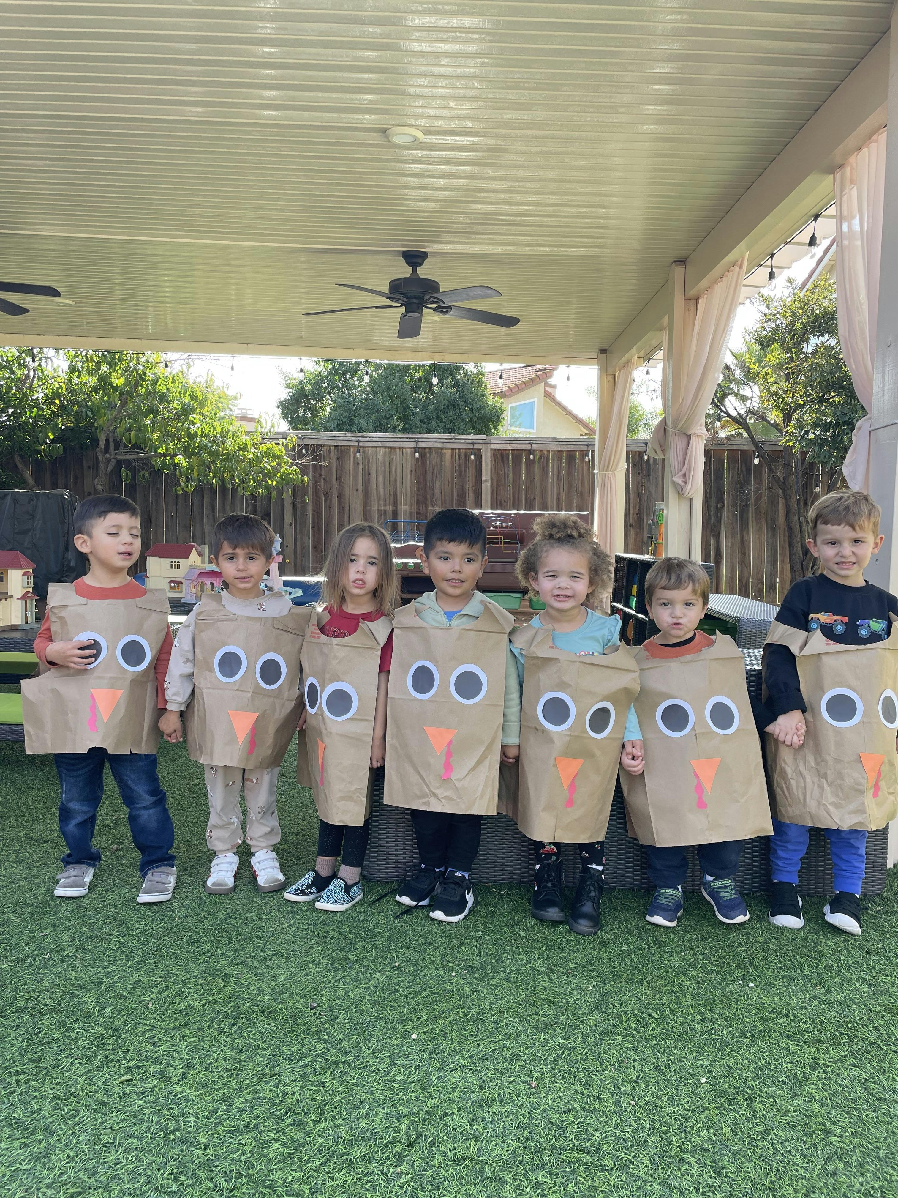 Group of children dressed in turkey costumes made from paper bags