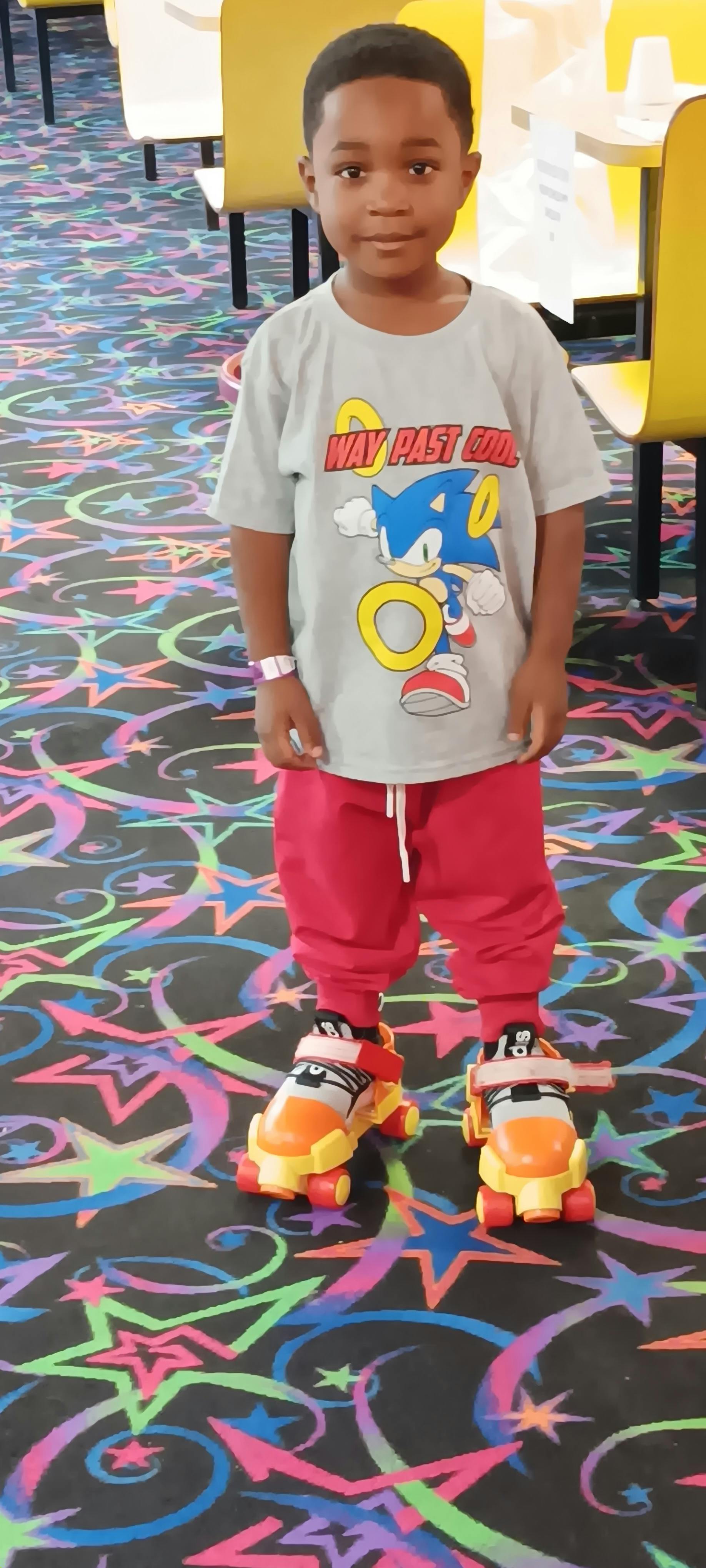 Child wearing a Sonic the Hedgehog shirt and roller skates