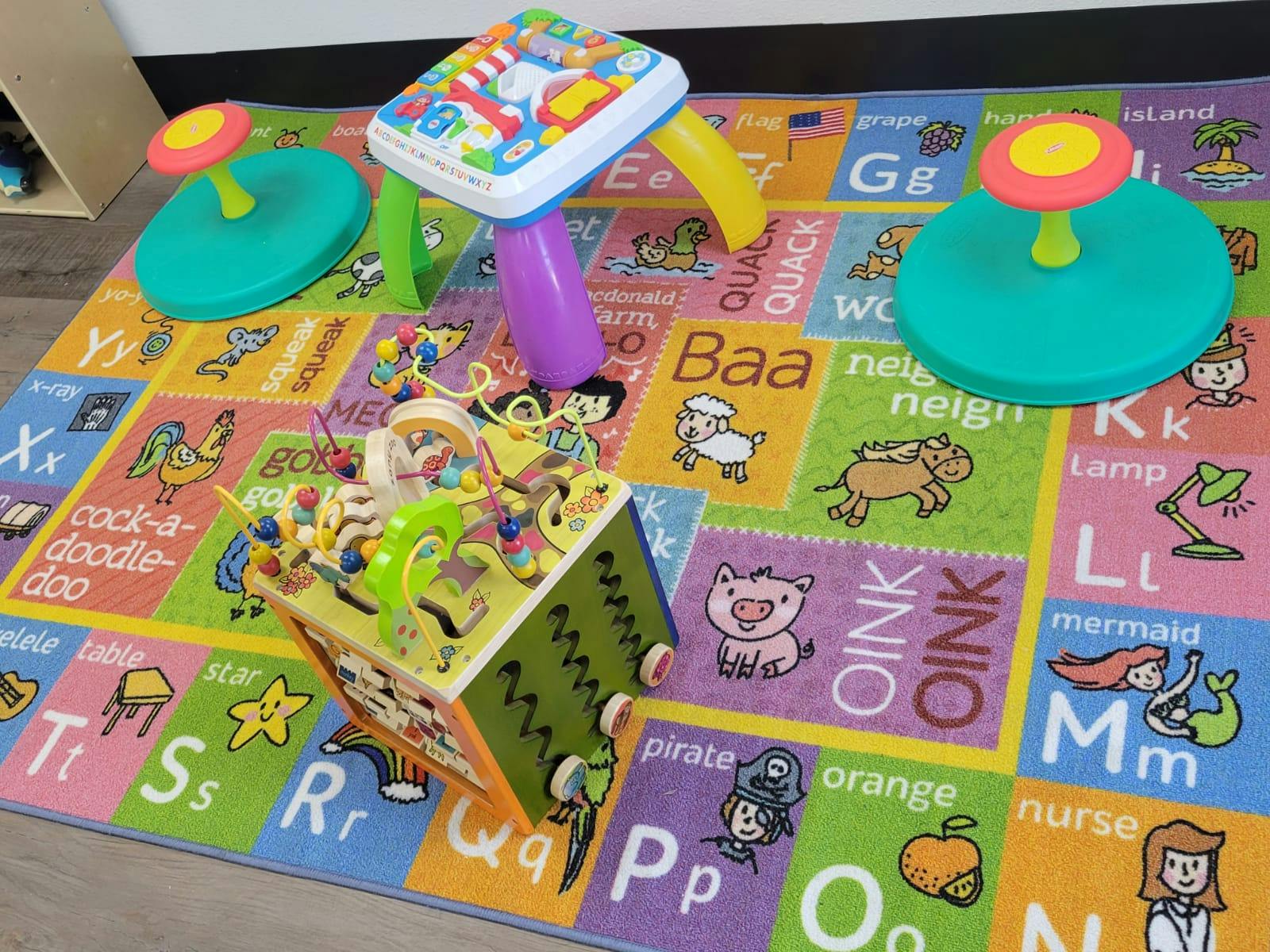 Children's toys on an alphabet playmat