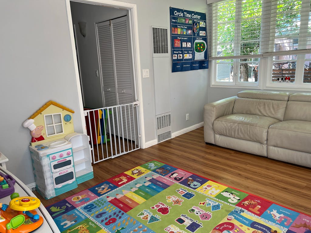 Play kitchen and colorful rug in a room with a sofa