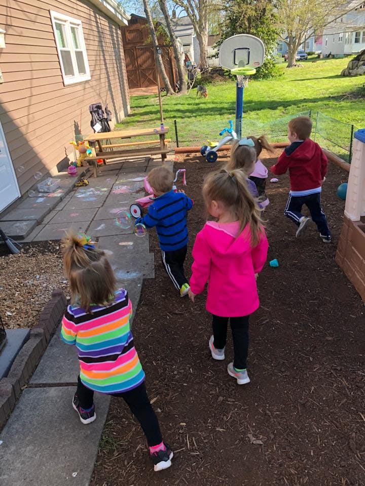 Children playing outdoors in a yard