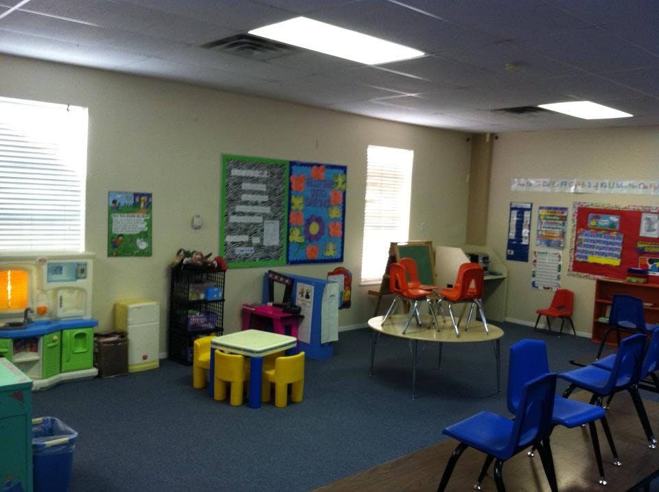 Empty classroom with small tables and chairs