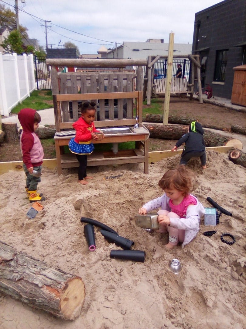 Children playing in a large sandbox