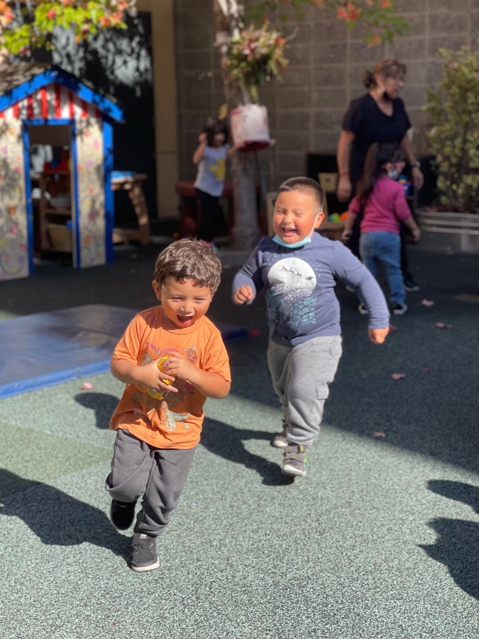 Two children running outdoors