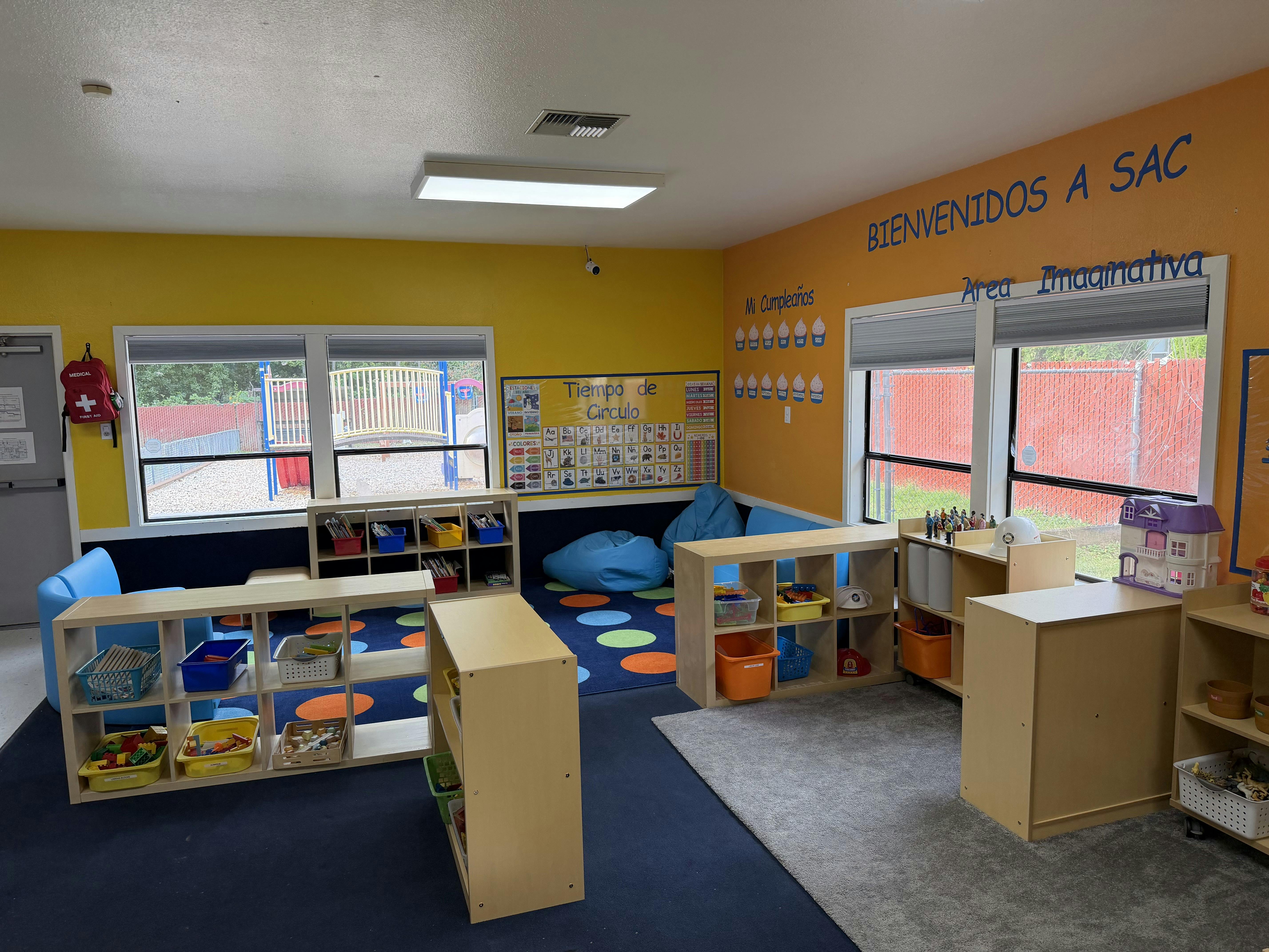 Classroom interior with educational posters and storage shelving for toys