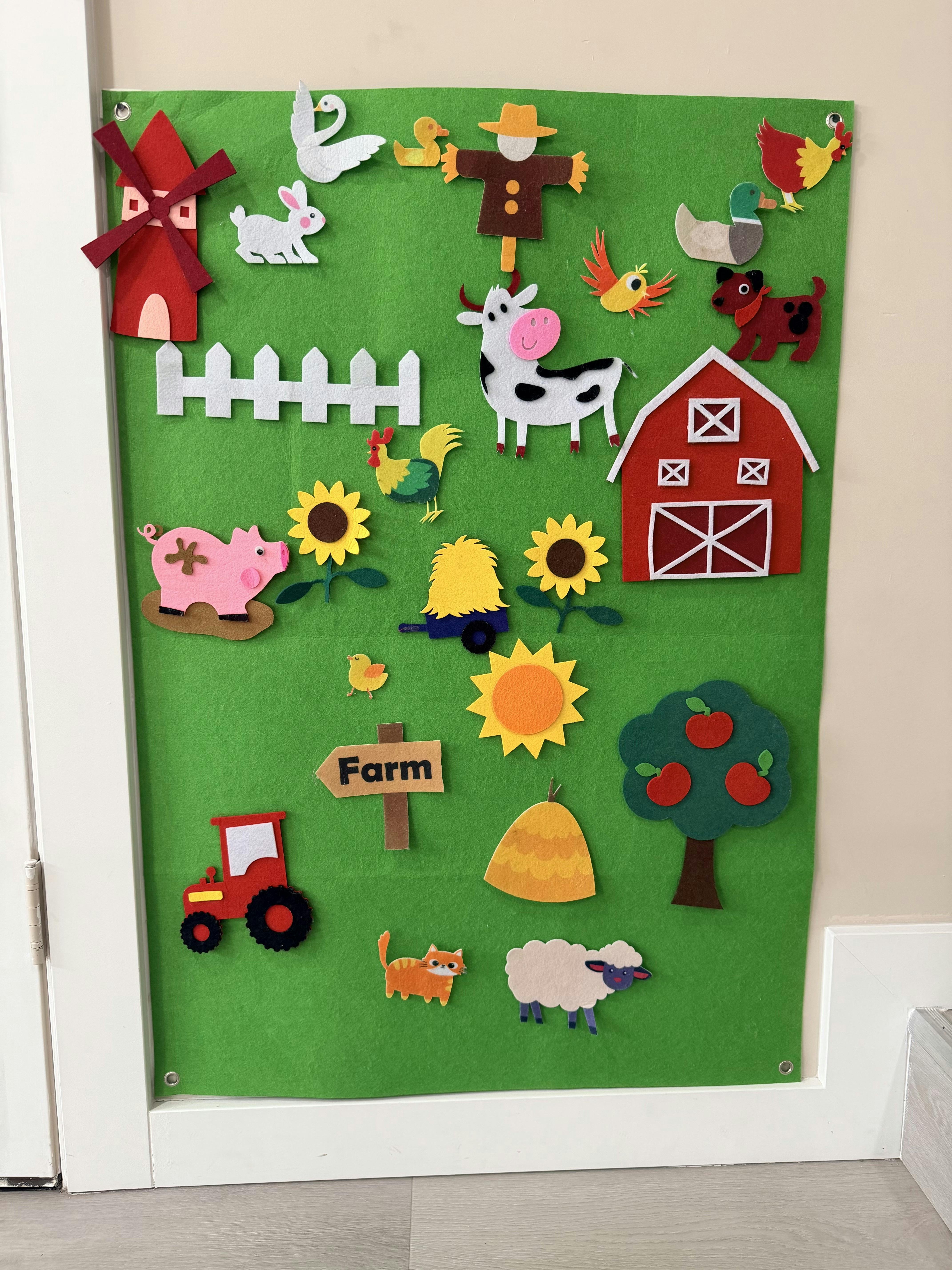 Felt farm scene with animals, barn, tractor, and a sign labeled Farm