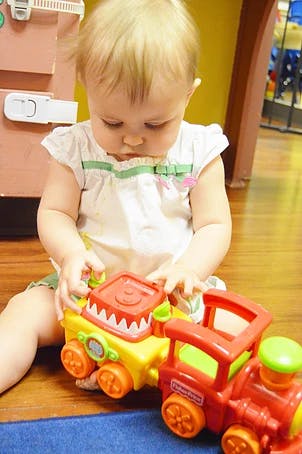 Child playing with a toy train