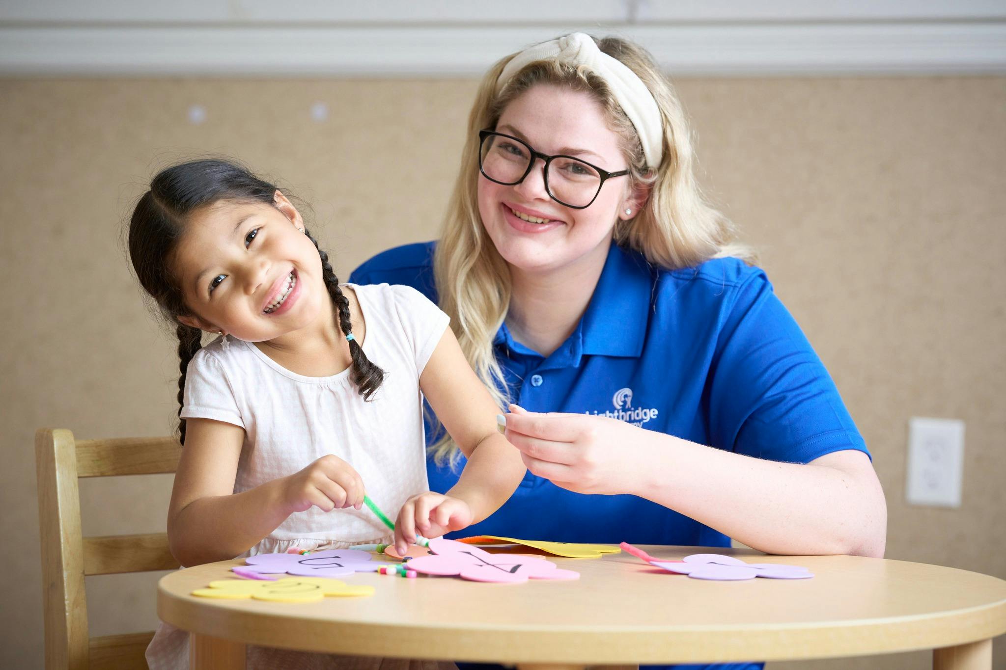 Adult and child doing crafts at a table