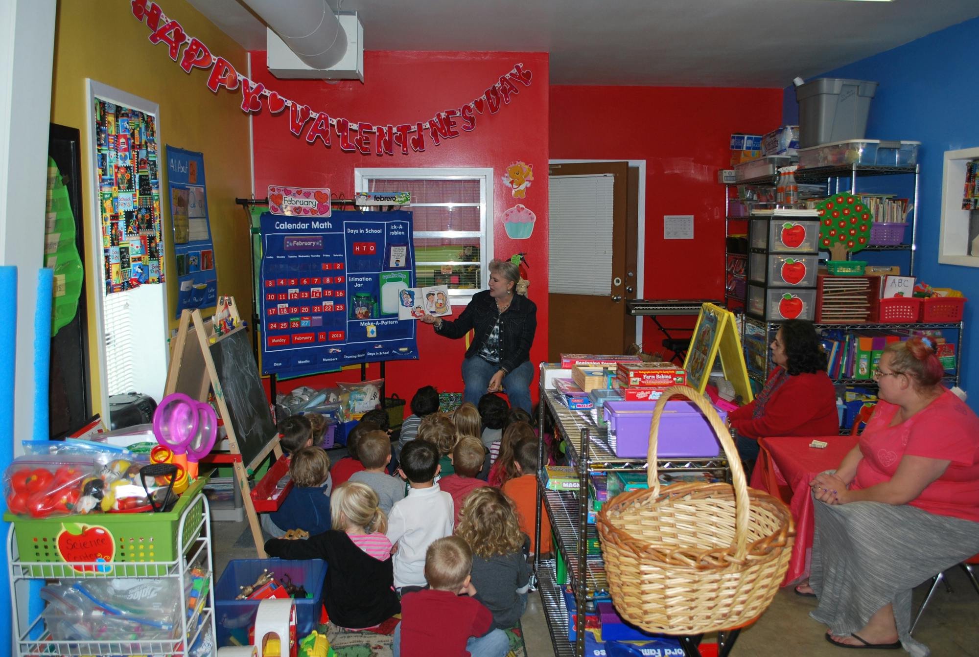 Adult reading to children in a classroom