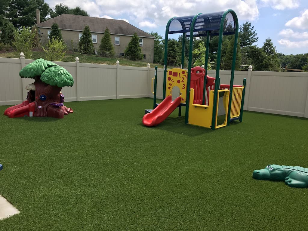 Playground with a tree-shaped slide and a colorful play structure