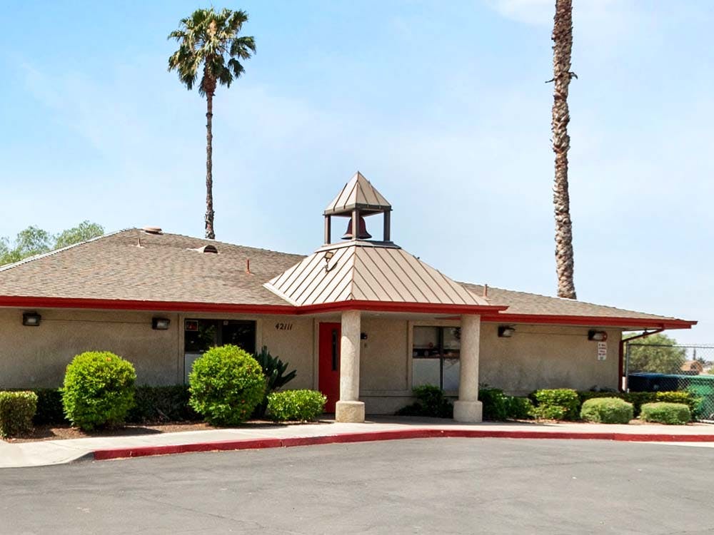 Building with 4211 written above the entrance and a bell tower on the roof