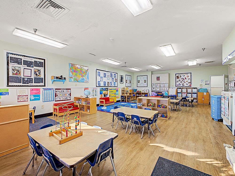 Classroom with tables, chairs, and learning materials